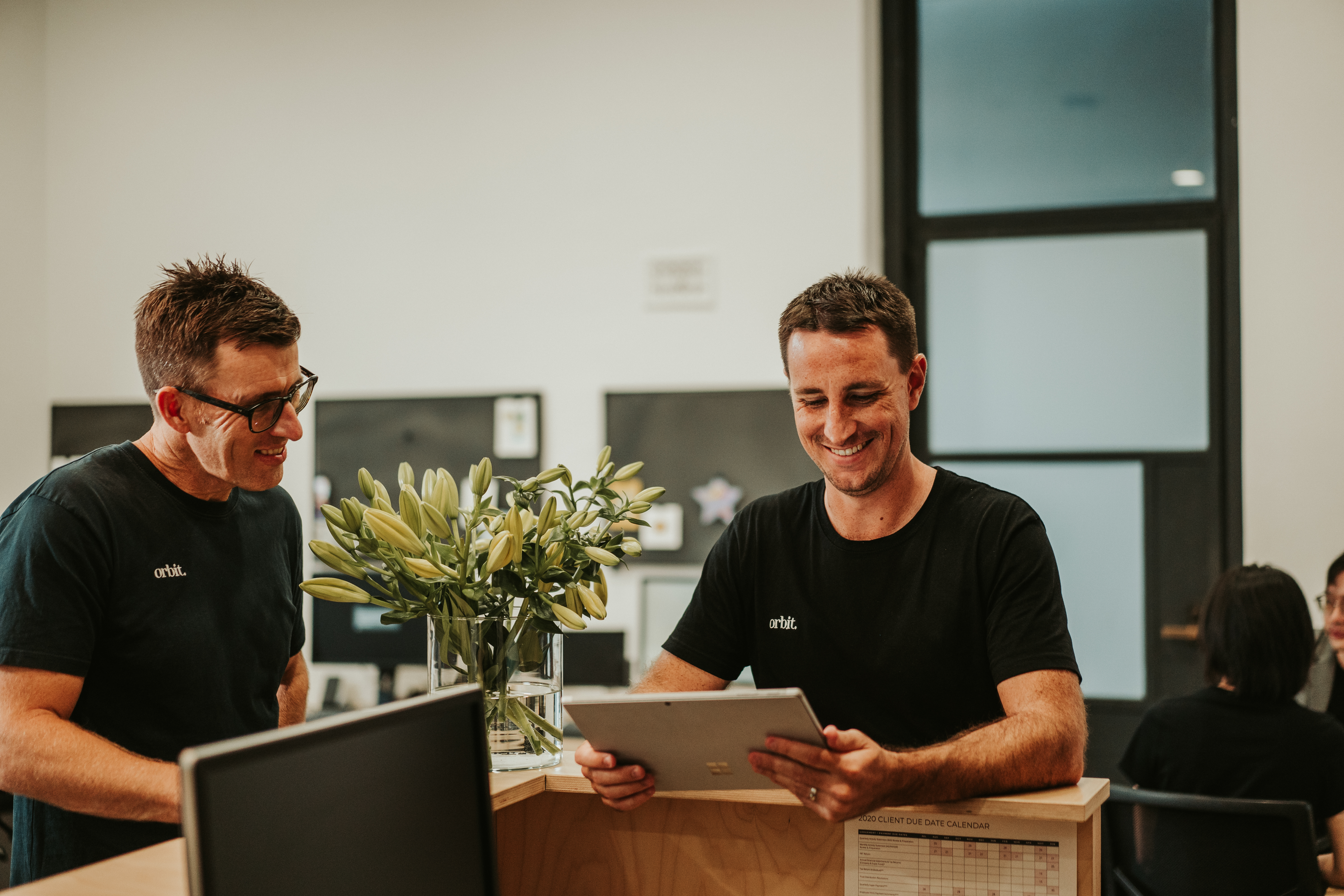 Orbit’s small business advisors conversing in their Sydney office
