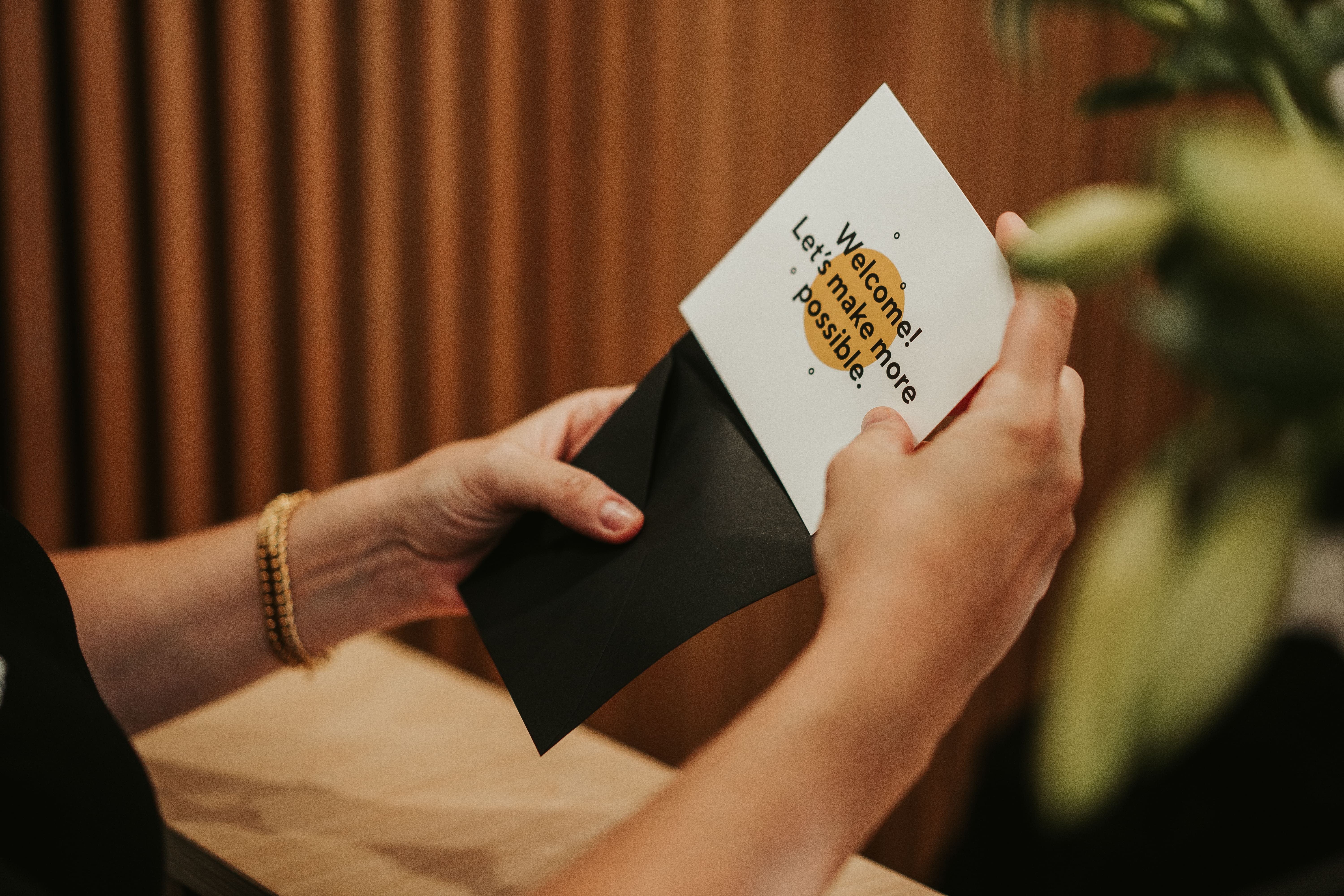 ‘welcome! Let’s Make More Possible’ Card Being Opened In Sydney Office Min