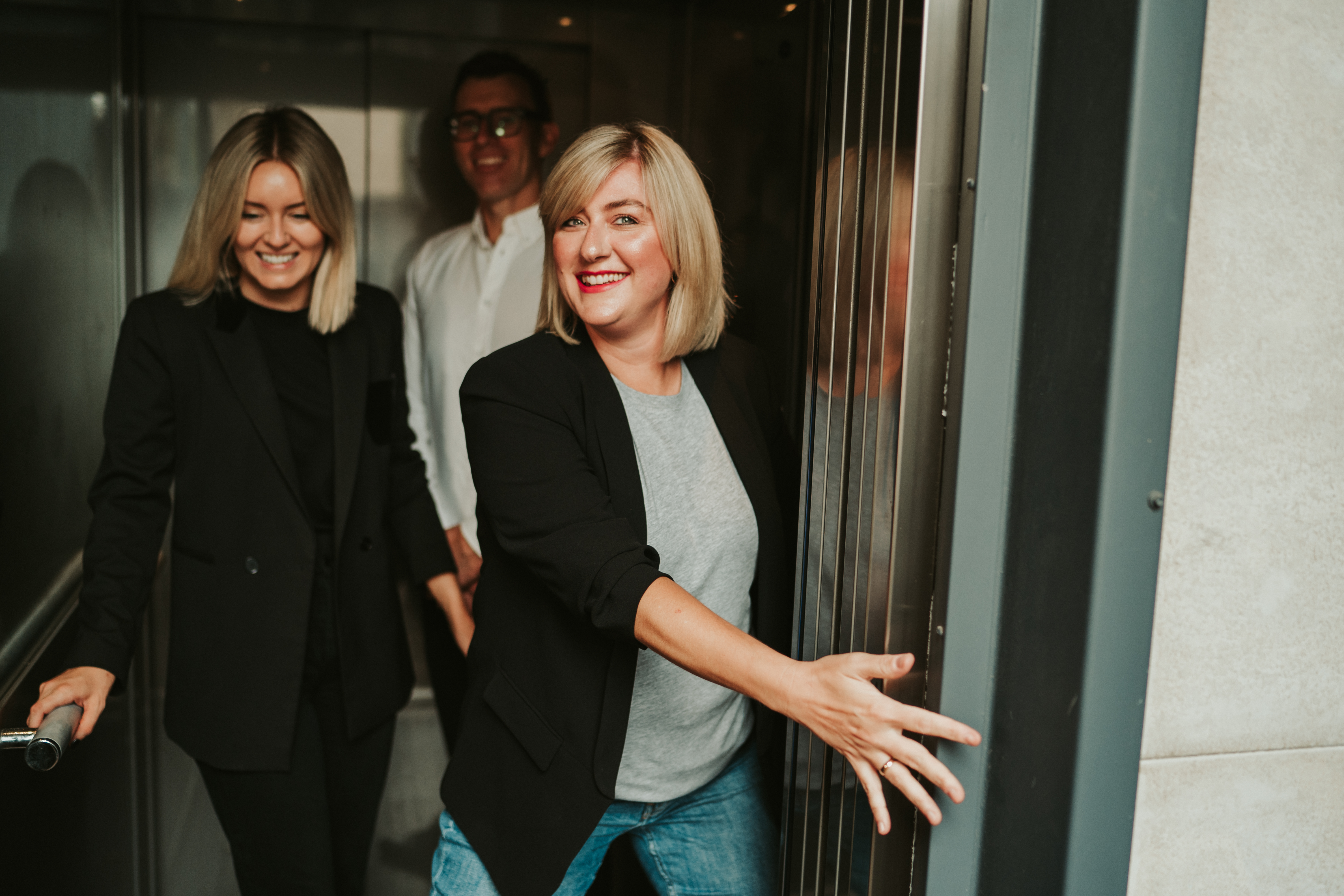 Amelia Holding Open Elevator Door In Orbit’s Randwick Office