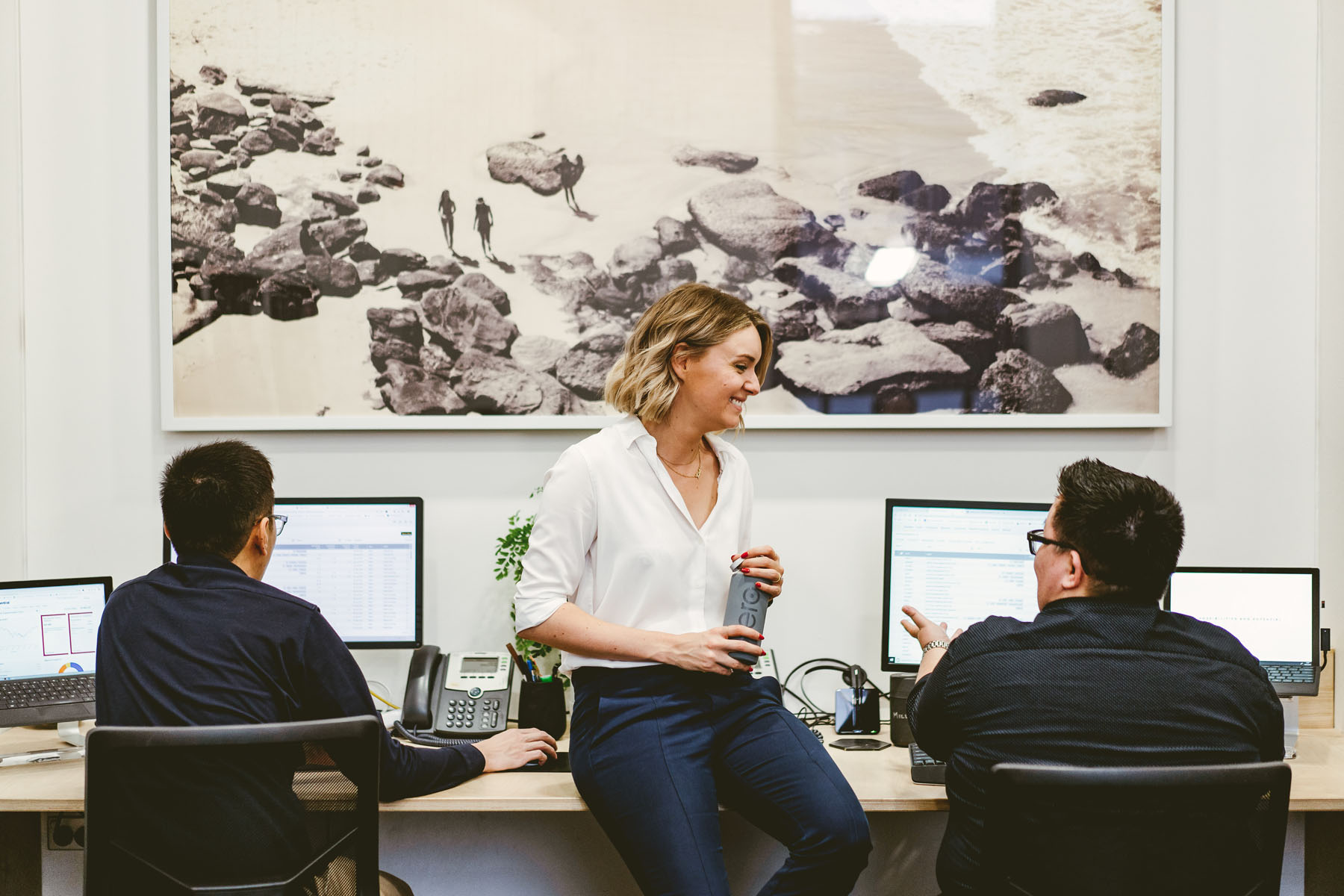 Co Founder, Kate, Holding A Xero Water Bottle And Discussing Accounts With Smsf Client Manager, Millinda, In The Sydney Office.