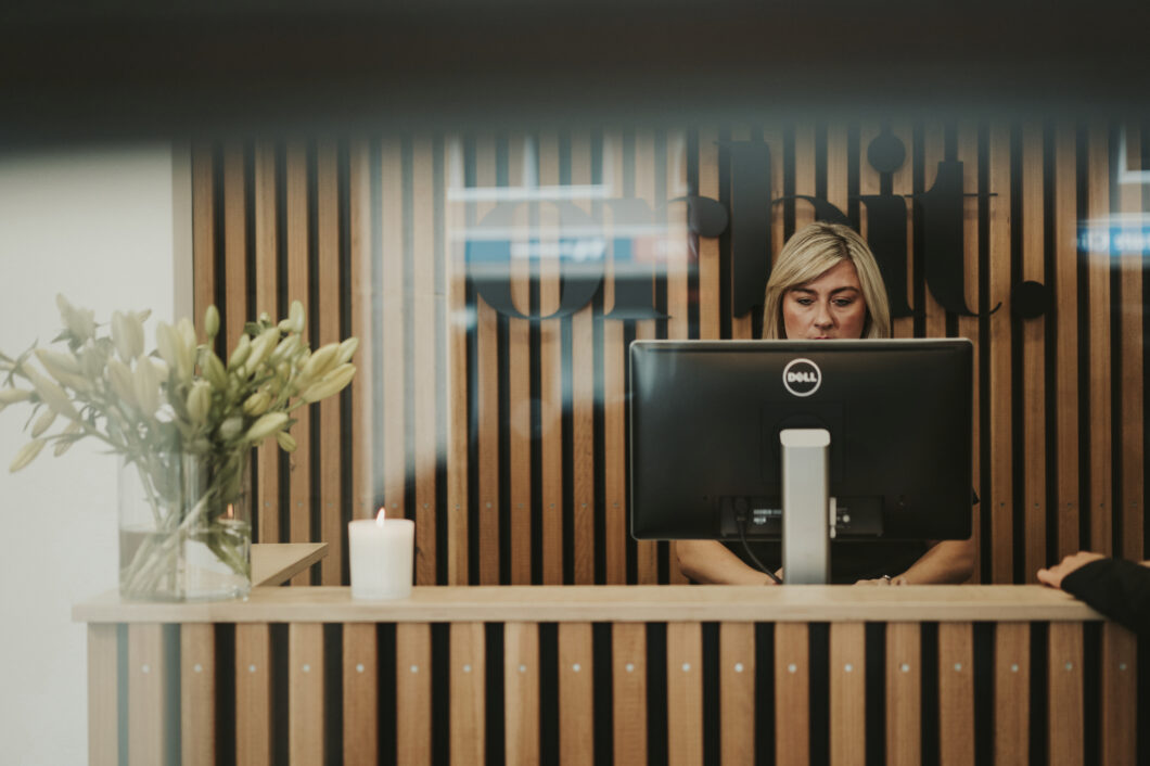 Orbit’s Client Manager, Amelia Carey, On The Business Computer In The Reception Of Sydney Office