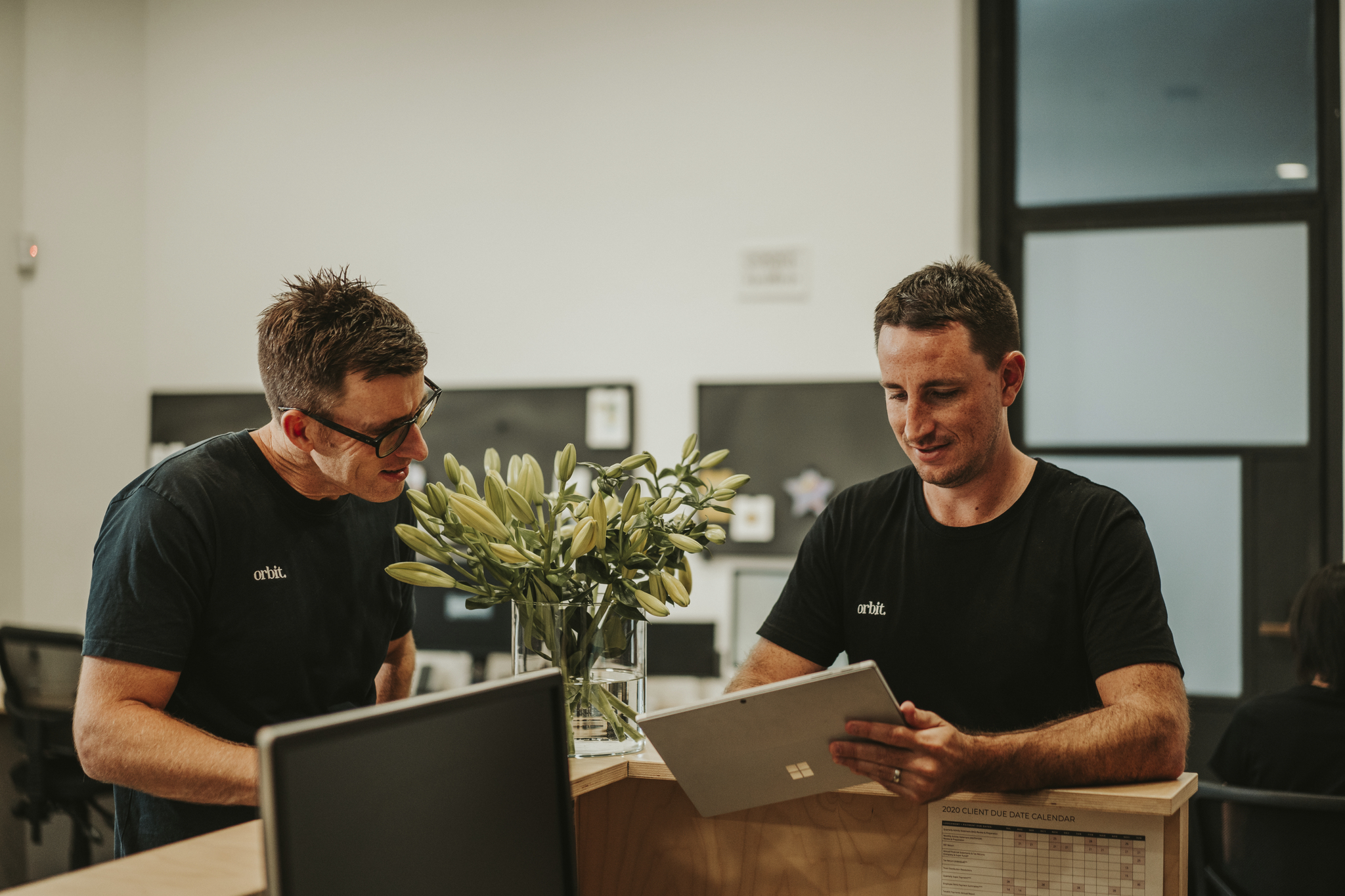 Orbit’s Co Founder, Cpa & Director, Greg Dennis, And Senior Accountant, Alex Golding, Conversing In The Reception Of Sydney Office